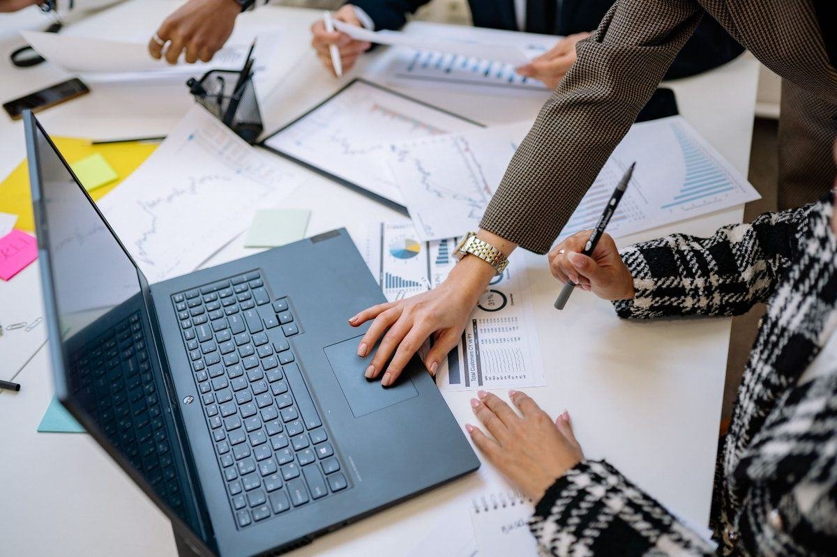 Equipe analisando dados e gráficos para identificar oportunidades em licitações públicas
